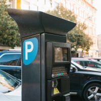 Machine for paying parking. Close-up - machine for paying parking on background of blurry cars